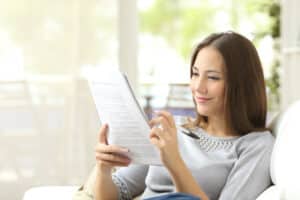 Clermont home inspection a woman calculating home budget Orlando home inspection a woman calculating home budget